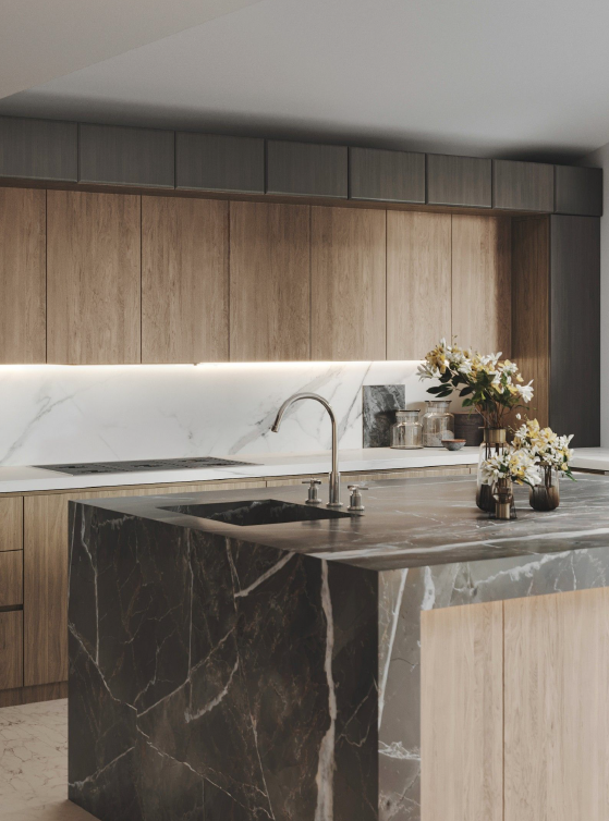 Kitchen detail with dark stone waterfall island, undermount sink, and wood cabinetry with marble backsplash.
